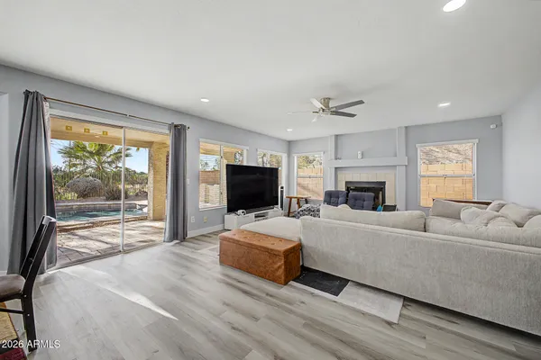 a living room with furniture a fireplace and a flat screen tv