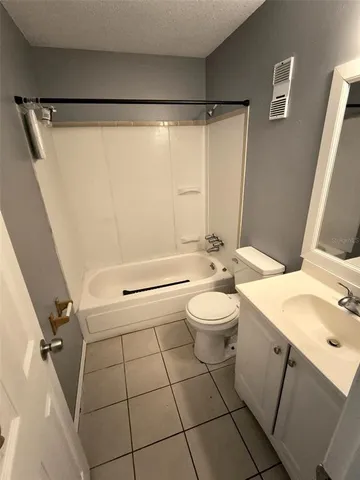 a bathroom with a sink mirror vanity and toilet