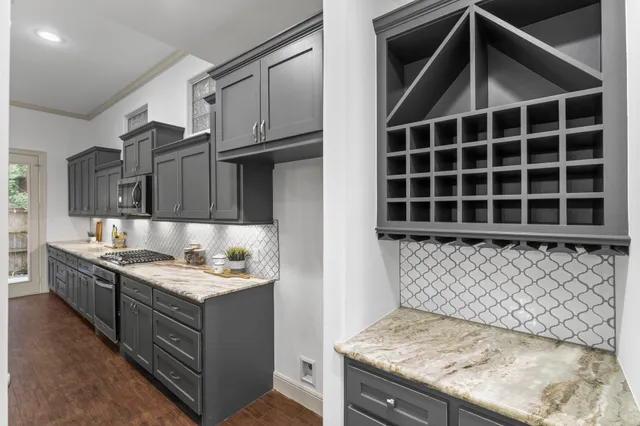 a kitchen with a sink a stove and cabinets