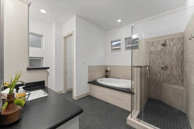 a spacious bathroom with a double vanity sink and a mirror