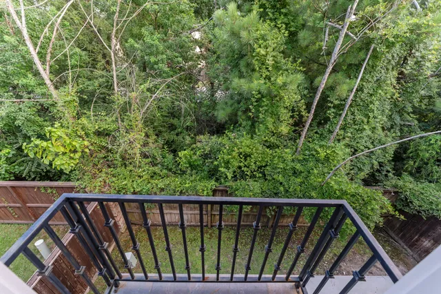 a balcony with trees in front of it