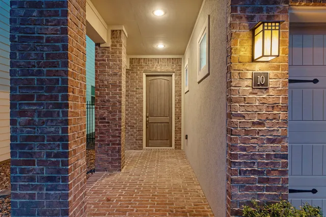 a view of a brick house with an outdoor space