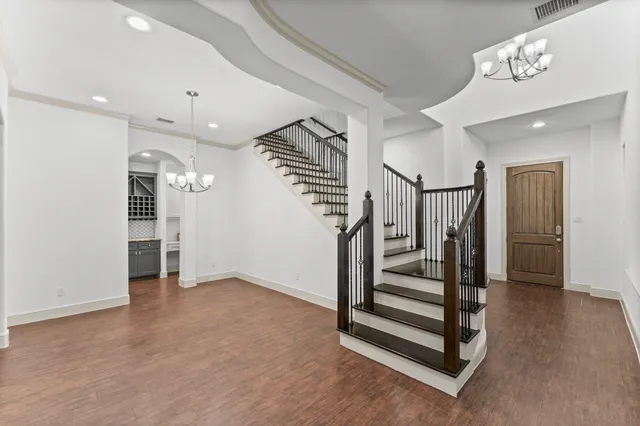 wooden floor in an empty room with a staircase