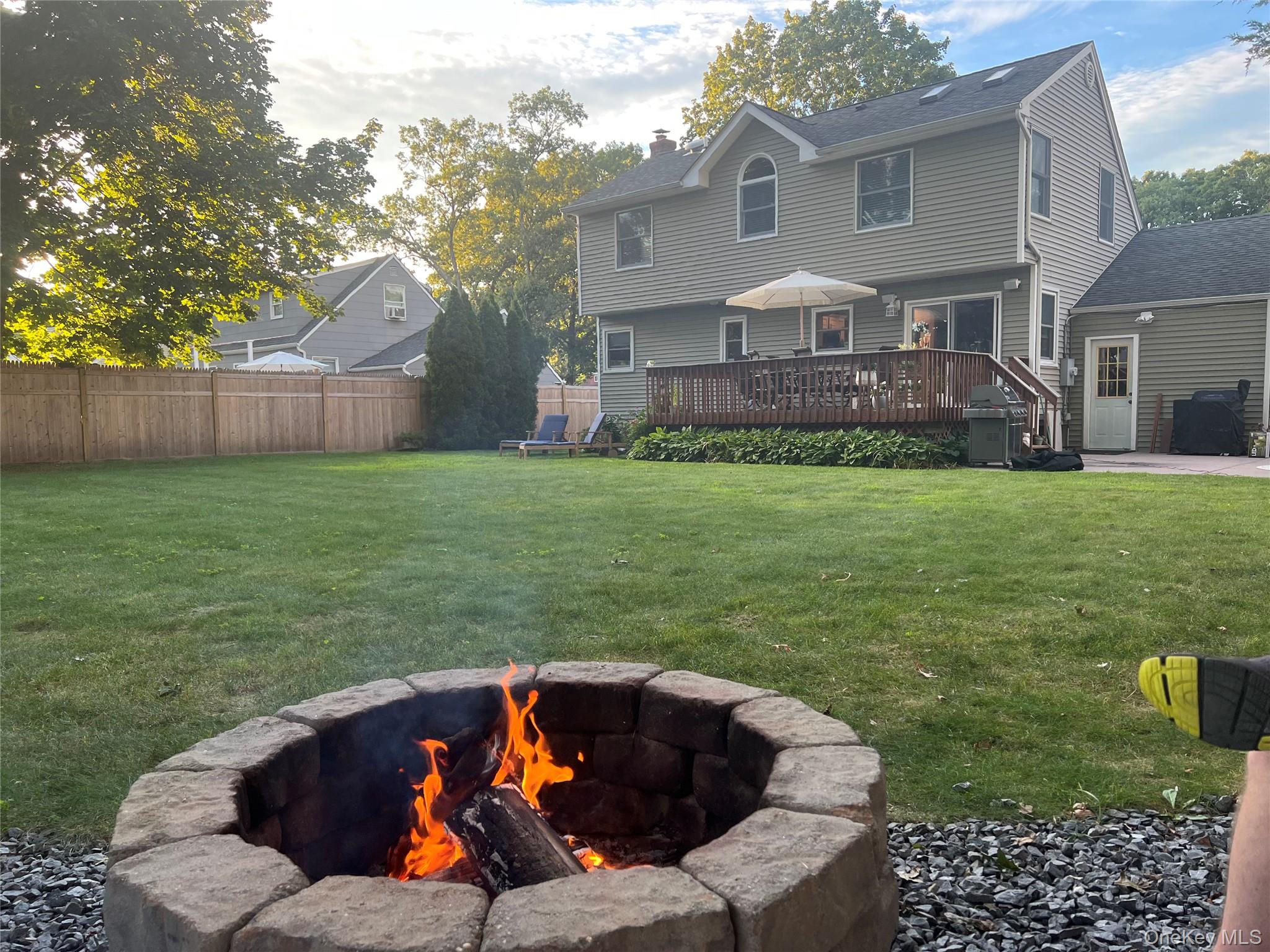 6 Robinson Street Shoreham, NY 11786 - Photo 27 of 28 a backyard of a house with table and chairs