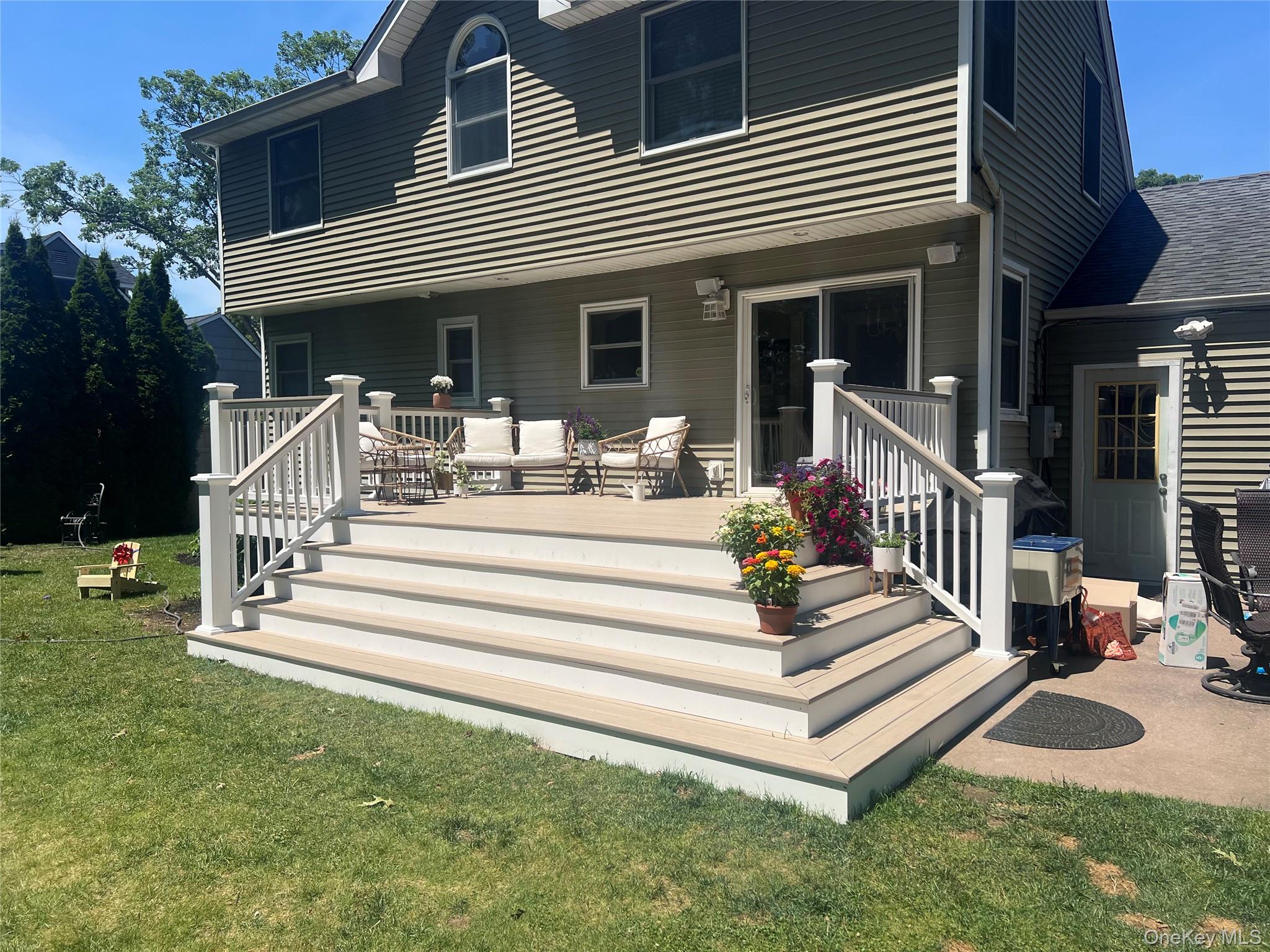 6 Robinson Street Shoreham, NY 11786 - Photo 3 of 28 a front view of a house with a yard table and chairs