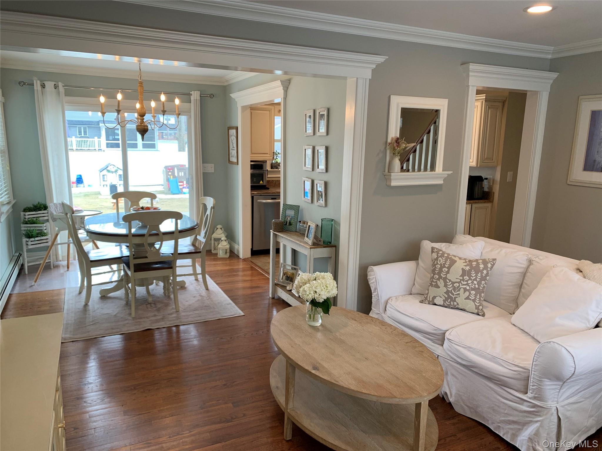 6 Robinson Street Shoreham, NY 11786 - Photo 7 of 28 a living room with furniture and a dining table with wooden floor