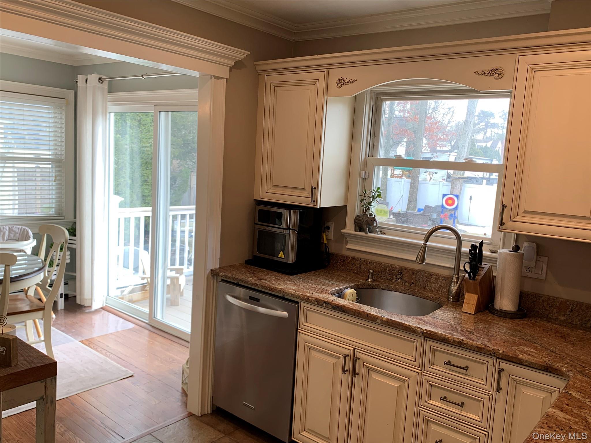 6 Robinson Street Shoreham, NY 11786 - Photo 10 of 28 a kitchen with granite countertop a stove a sink and a window