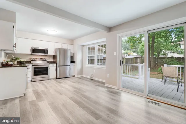 a view of a kitchen with a stove top oven and a kitchen island