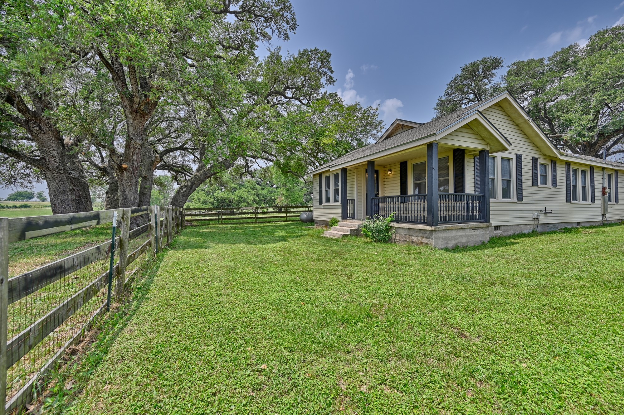 7009 Sandy Hill Road Brenham, TX 77833 - Photo 15 of 41 a front view of a house with a yard