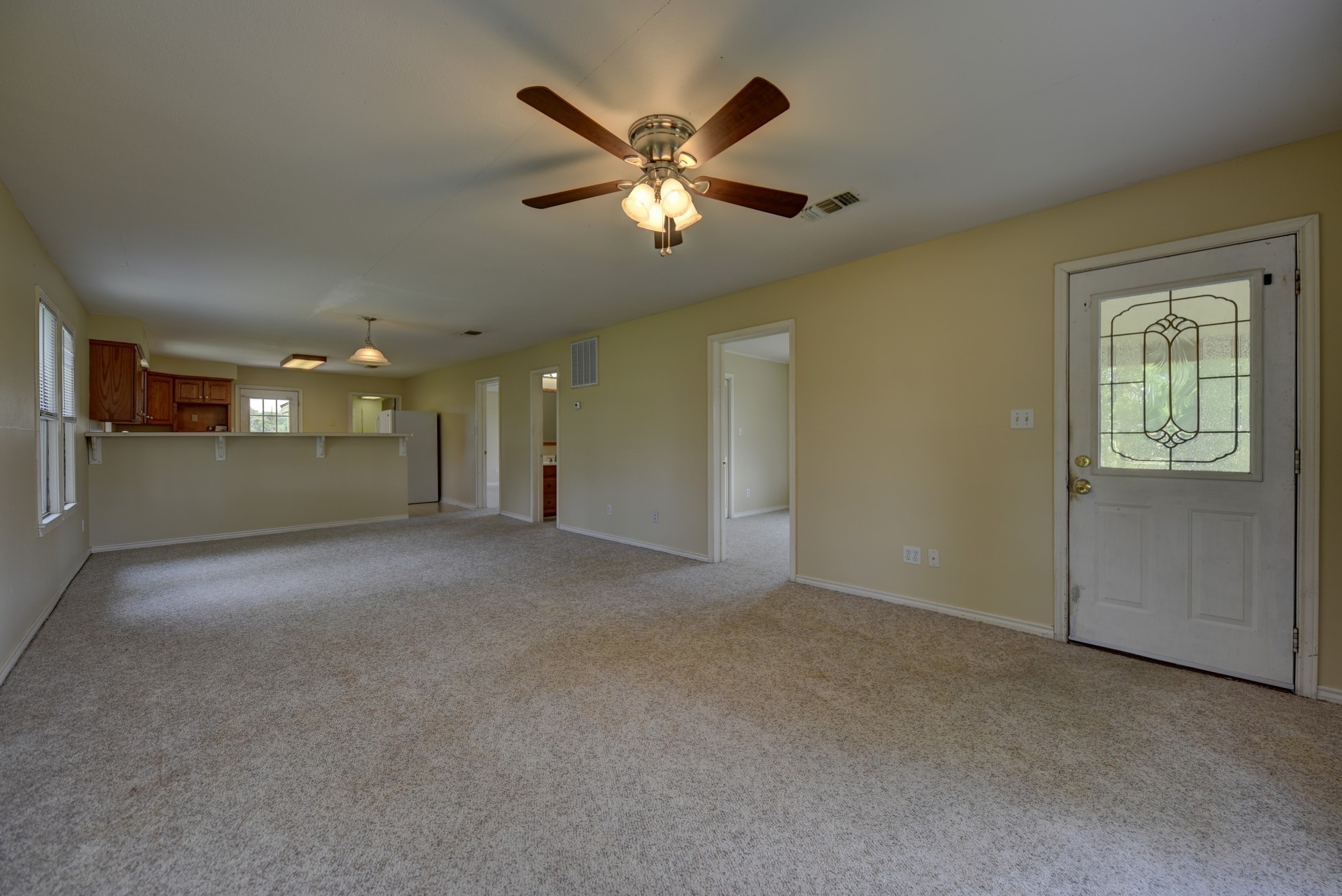 7009 Sandy Hill Road Brenham, TX 77833 - Photo 19 of 41 a view of an empty room with window and a ceiling fan
