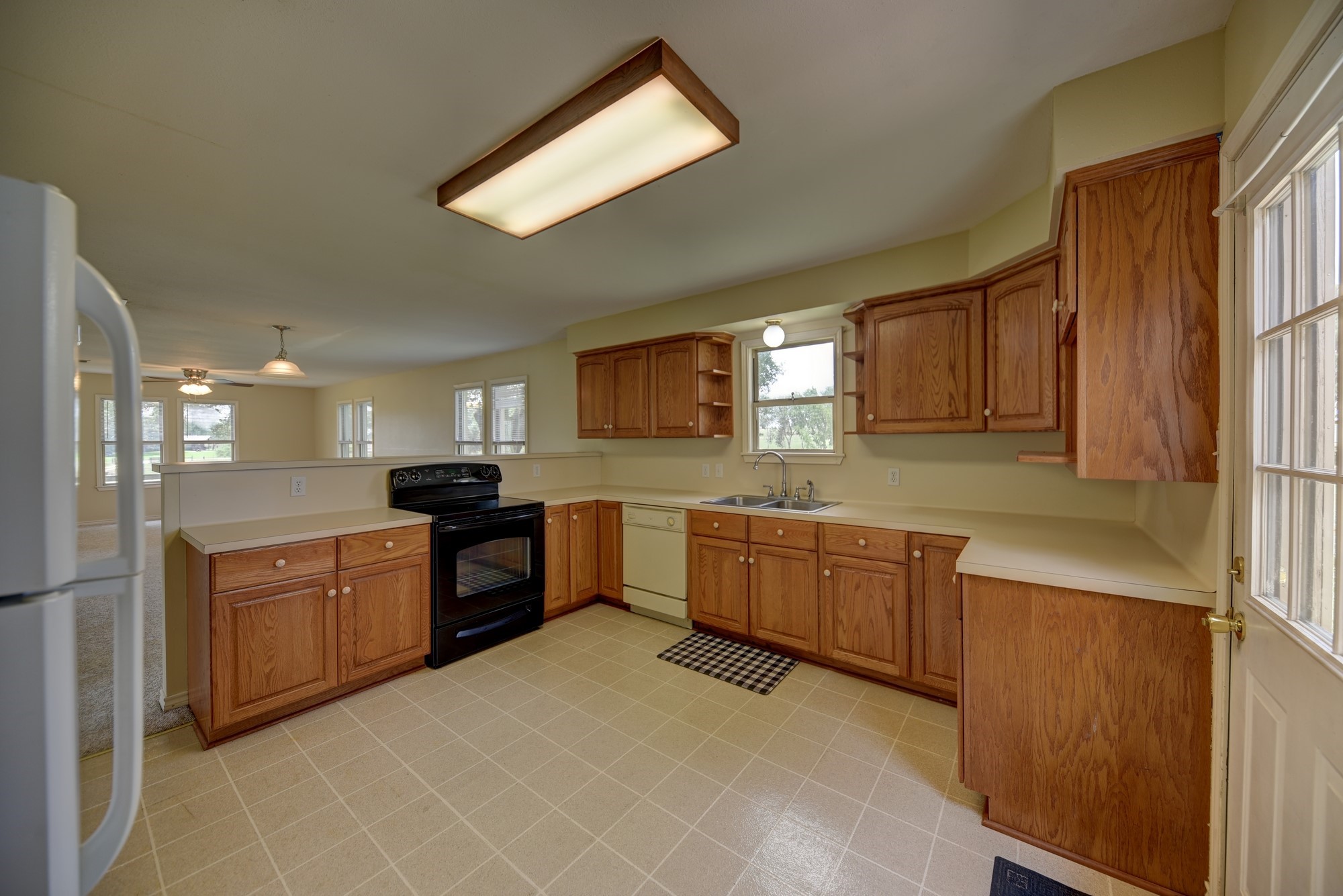 7009 Sandy Hill Road Brenham, TX 77833 - Photo 21 of 41 a large kitchen with a stove a sink dishwasher a refrigerator and a microwave oven