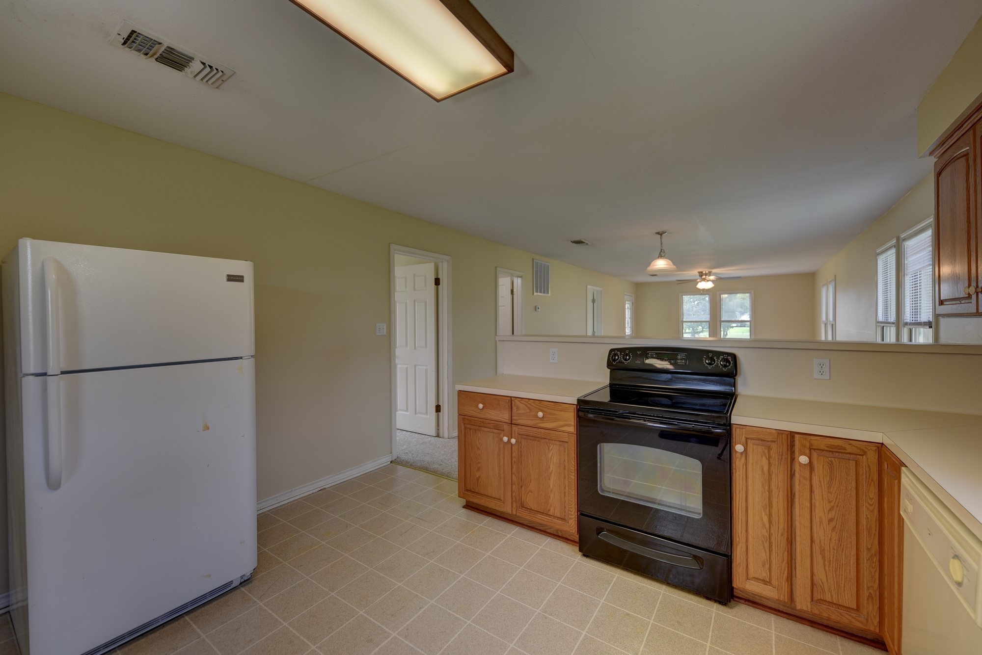 7009 Sandy Hill Road Brenham, TX 77833 - Photo 22 of 41 a kitchen with a refrigerator and a stove top oven