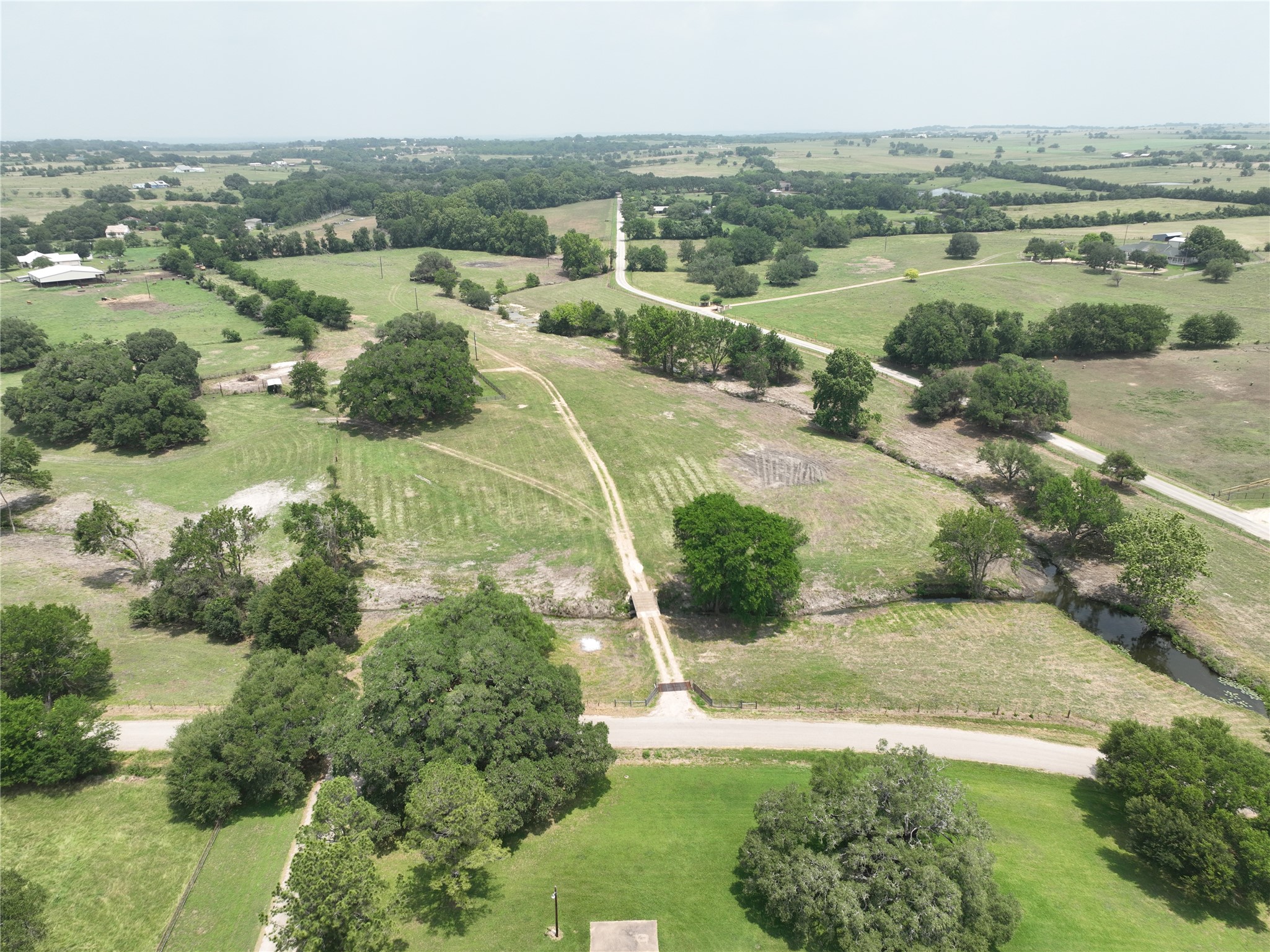 7009 Sandy Hill Road Brenham, TX 77833 - Photo 7 of 41 an aerial view of residential houses with outdoor space and trees