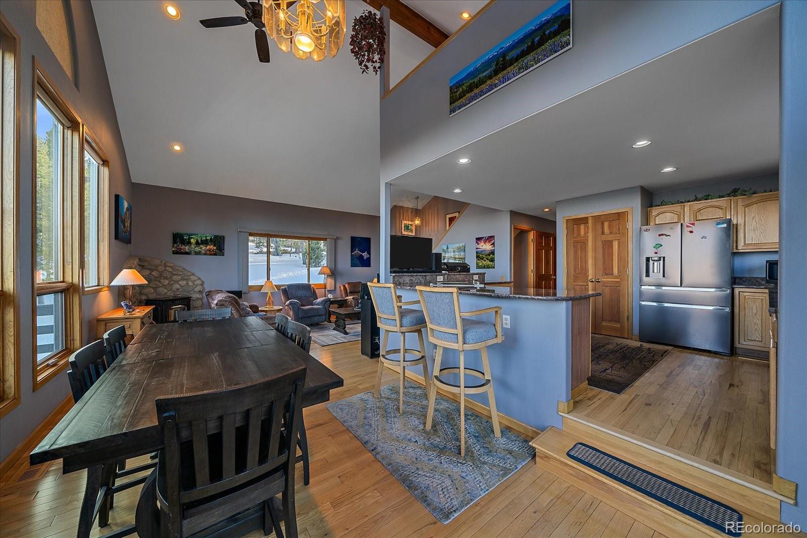 11222 Conifer Mountain Road Conifer, CO 80433 - Photo 14 of 49 a view of a dining room with furniture a rug and wooden floor