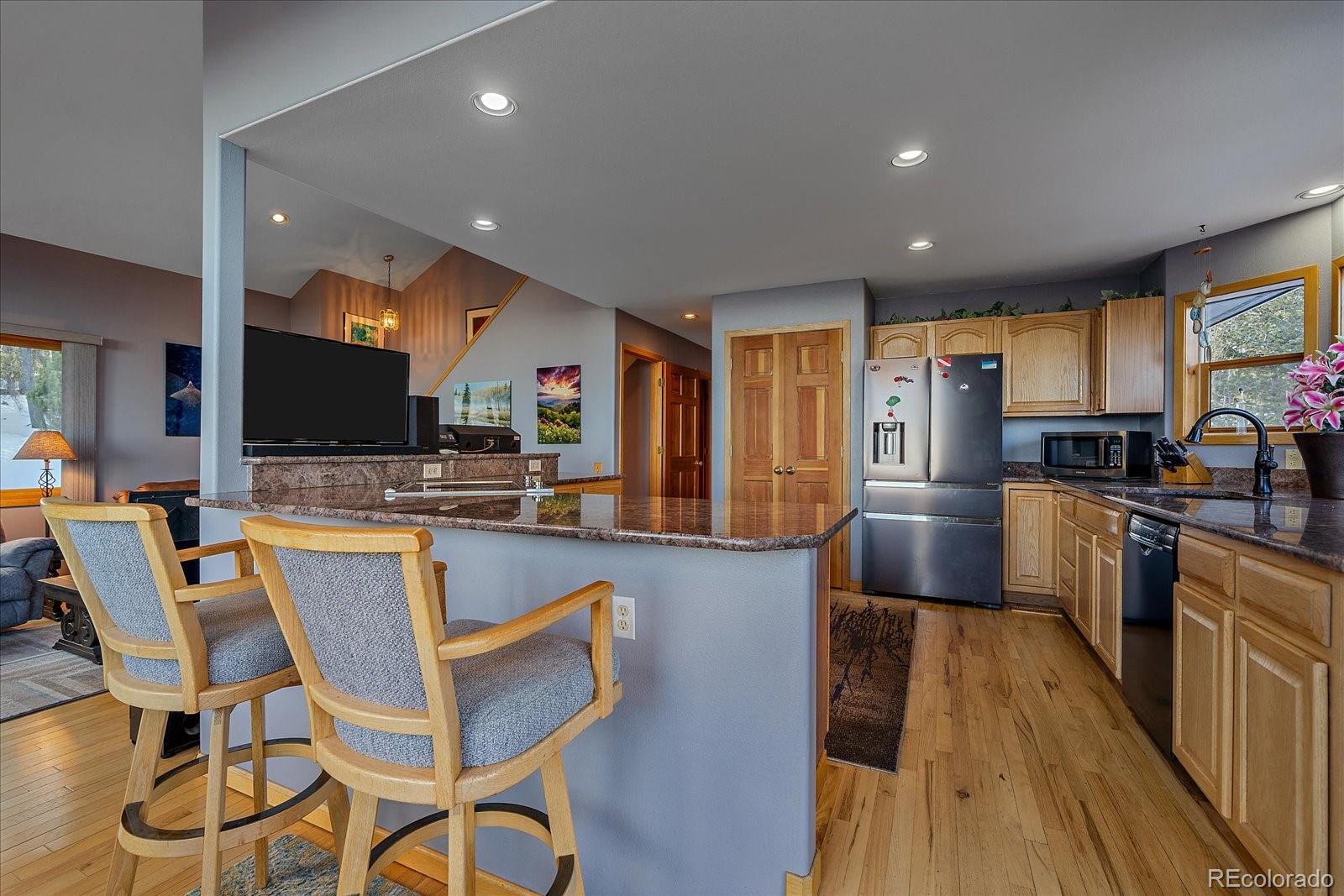 11222 Conifer Mountain Road Conifer, CO 80433 - Photo 15 of 49 a large kitchen with lots of counter space and stainless steel appliances