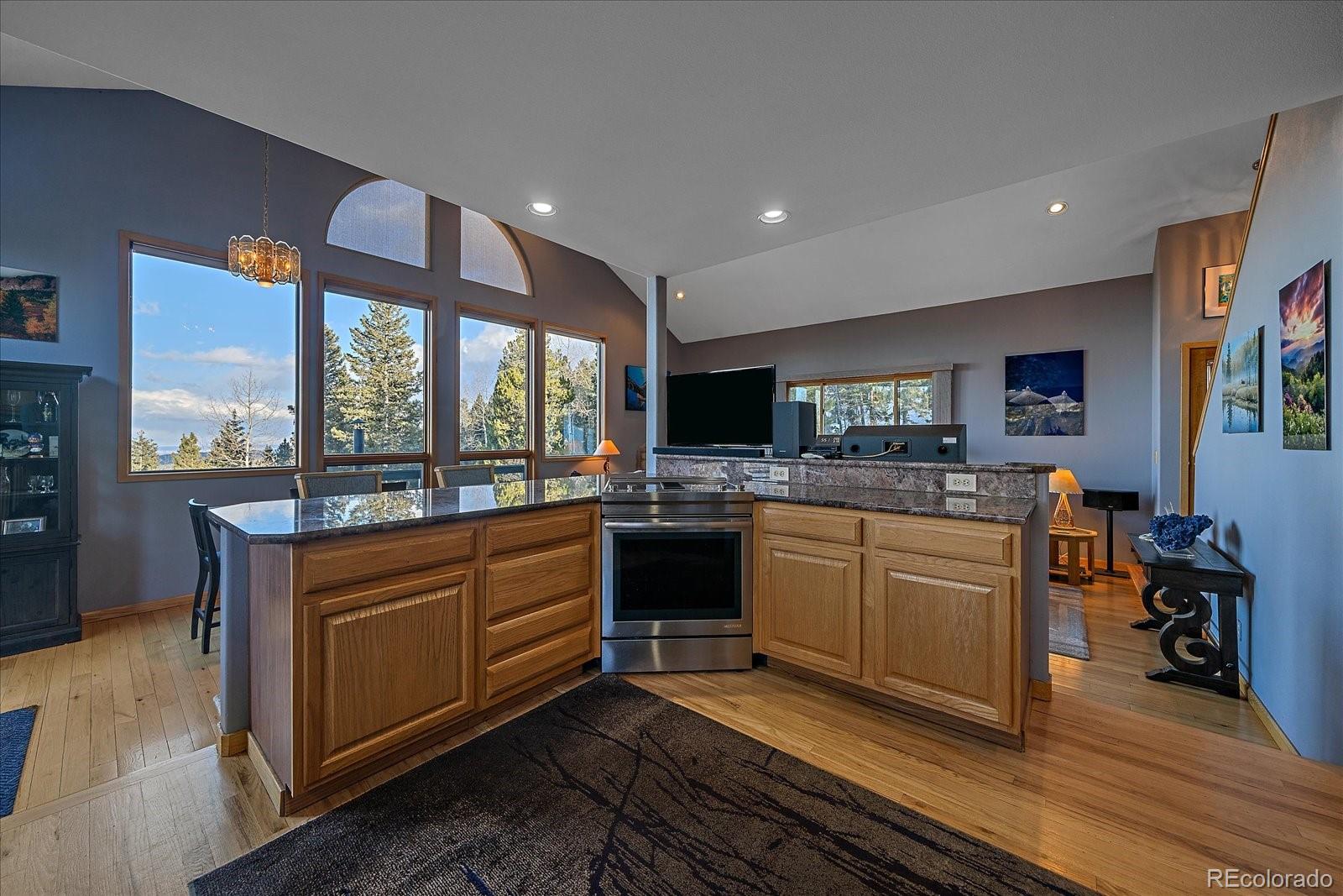 11222 Conifer Mountain Road Conifer, CO 80433 - Photo 18 of 49 a kitchen with stainless steel appliances granite countertop a stove and a sink
