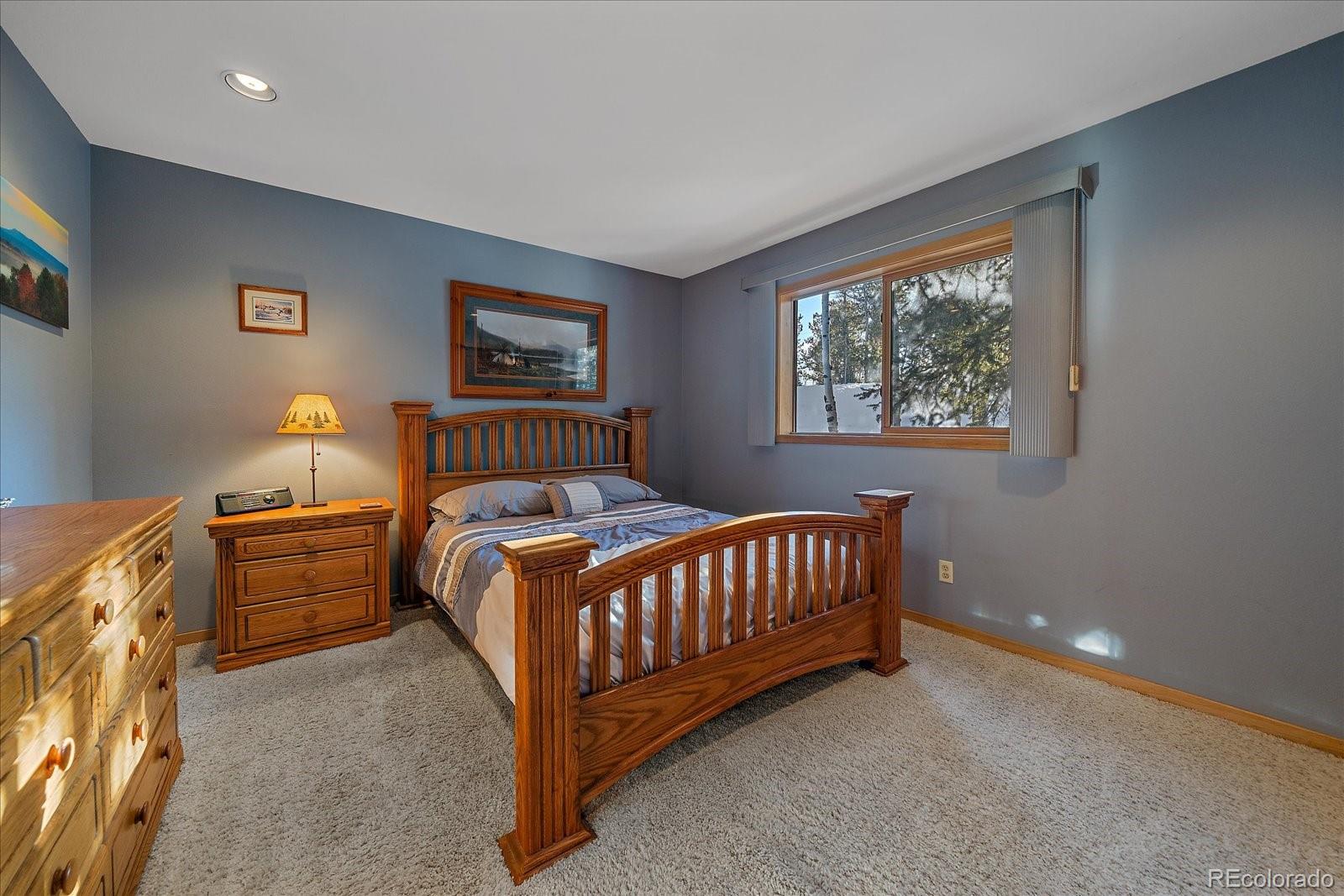 11222 Conifer Mountain Road Conifer, CO 80433 - Photo 20 of 49 a bedroom with furniture and a window
