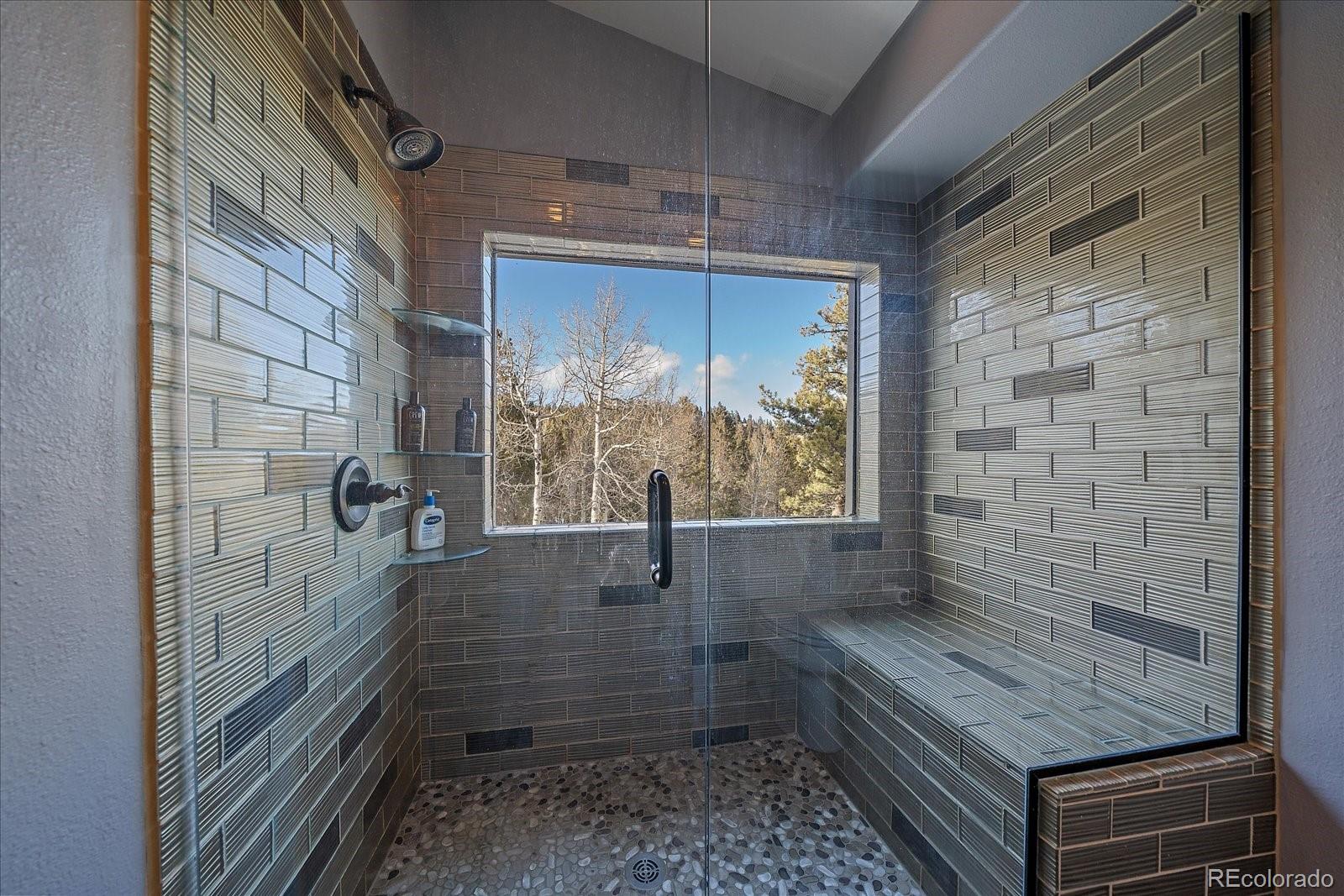 11222 Conifer Mountain Road Conifer, CO 80433 - Photo 31 of 49 a bathroom with a shower