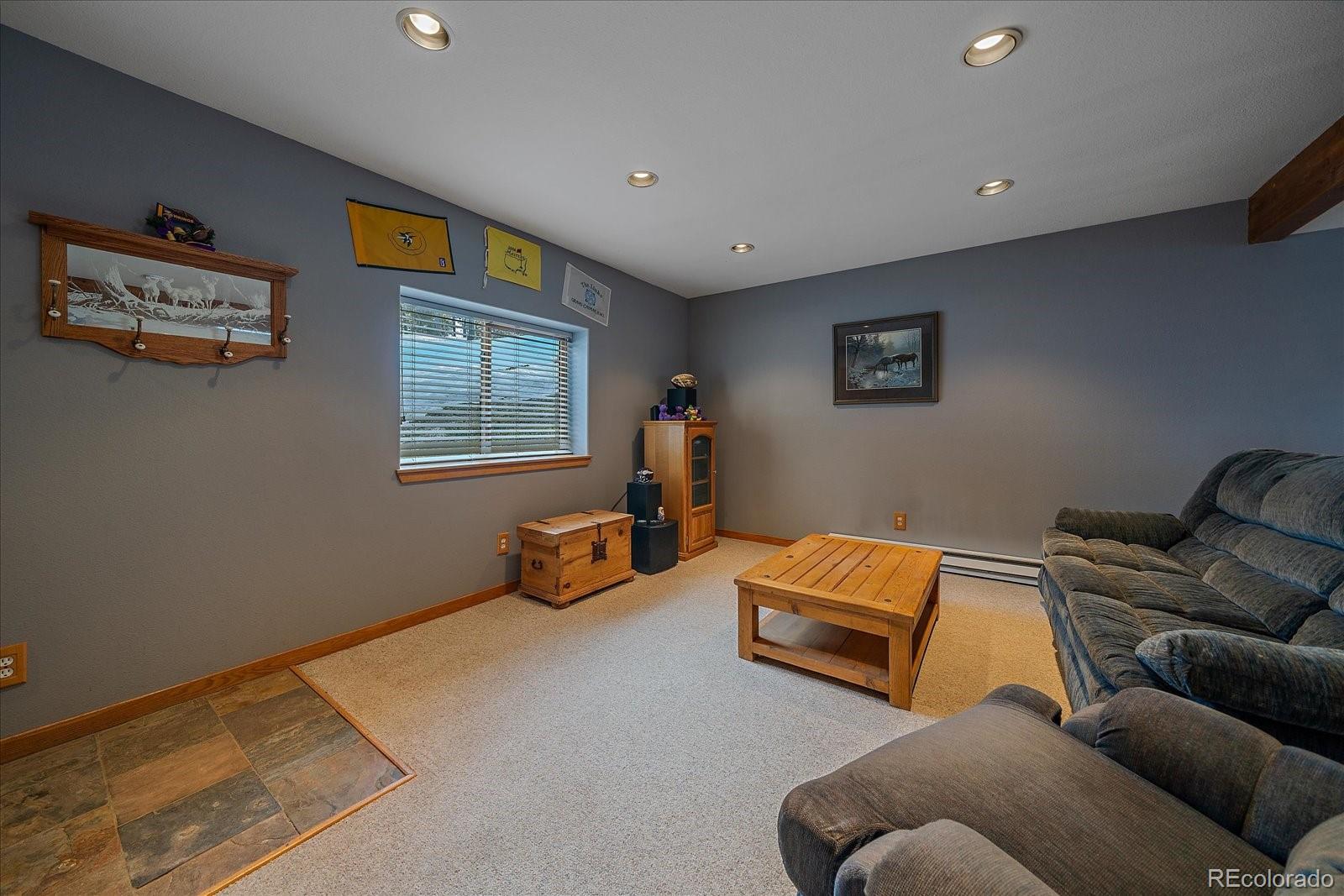 11222 Conifer Mountain Road Conifer, CO 80433 - Photo 33 of 49 a living room with furniture and a window
