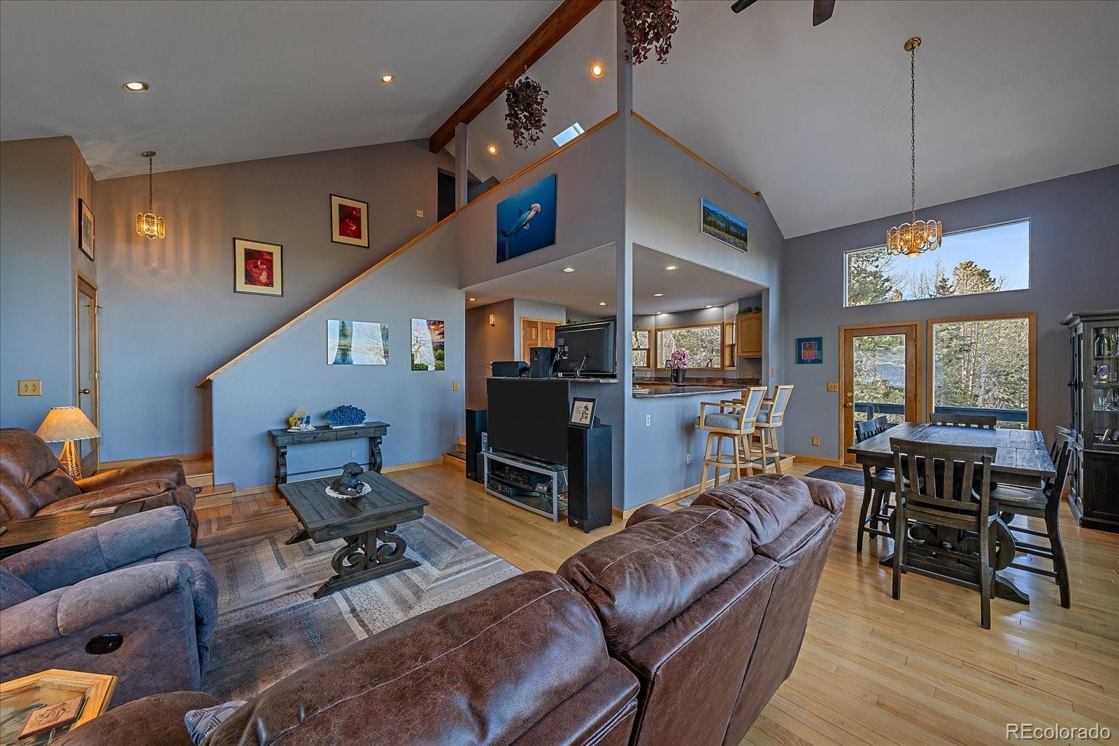 11222 Conifer Mountain Road Conifer, CO 80433 - Photo 4 of 49 a living room with furniture and wooden floor