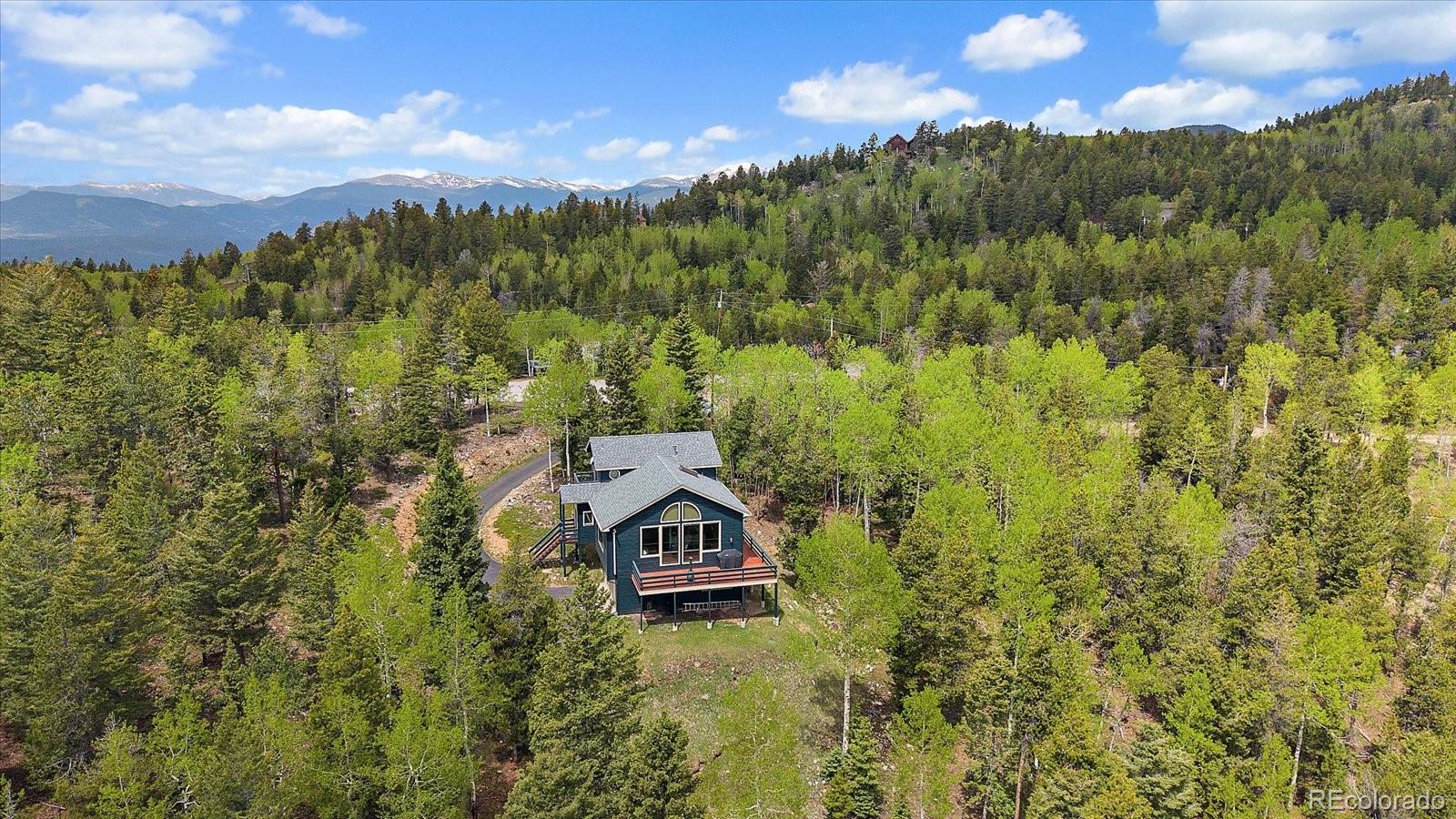 11222 Conifer Mountain Road Conifer, CO 80433 - Photo 43 of 49 a view of a city with lush green forest
