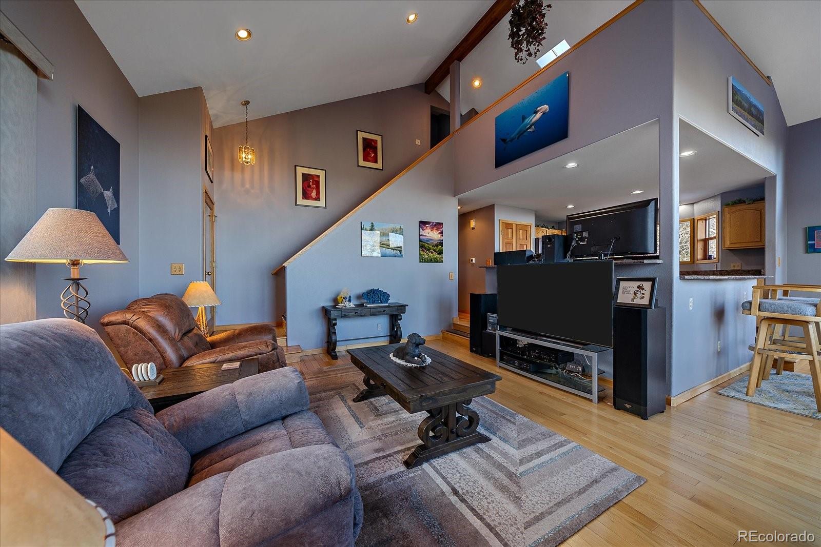 11222 Conifer Mountain Road Conifer, CO 80433 - Photo 5 of 49 a living room with furniture and a flat screen tv