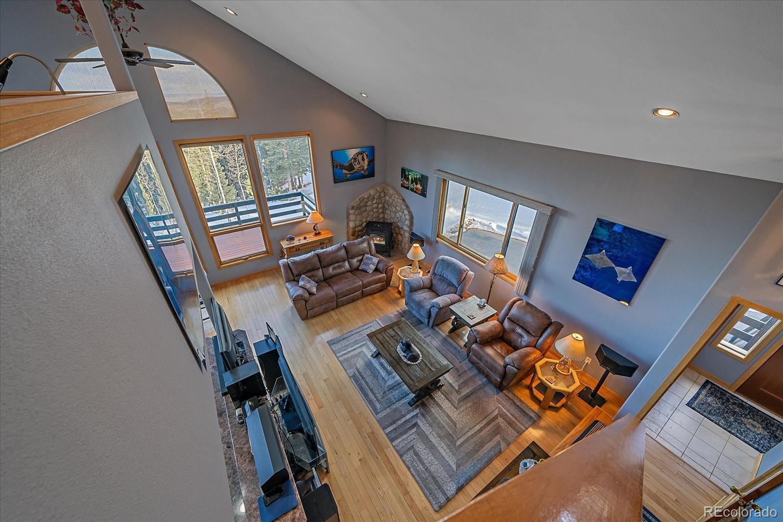 11222 Conifer Mountain Road Conifer, CO 80433 - Photo 6 of 49 a living room with furniture and a window