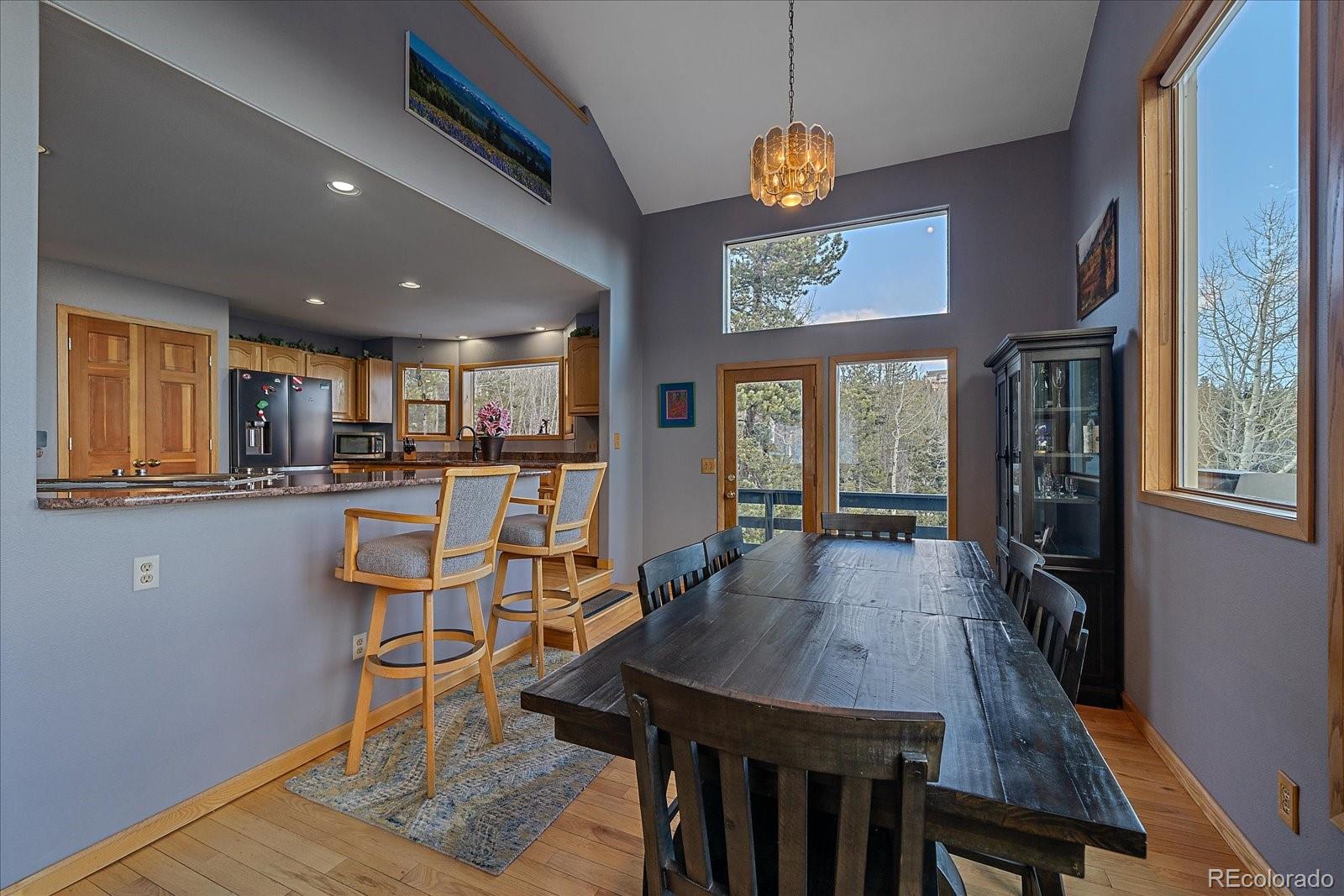 11222 Conifer Mountain Road Conifer, CO 80433 - Photo 7 of 49 a view of a dining room with furniture window and wooden floor
