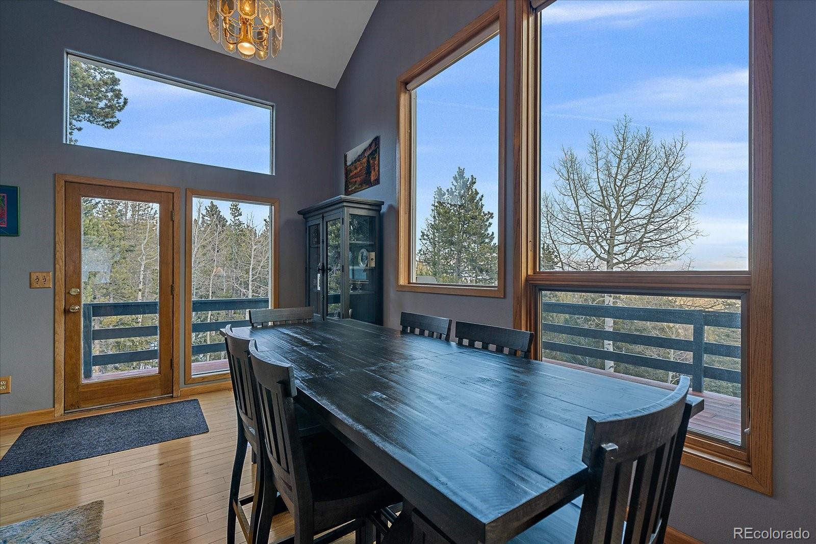 11222 Conifer Mountain Road Conifer, CO 80433 - Photo 8 of 49 a view of a dining room with furniture window and wooden floor