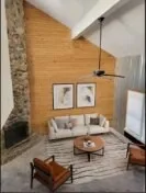 a living room with furniture and a ceiling fan