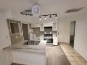 a kitchen with stainless steel appliances kitchen island granite countertop a sink and cabinets