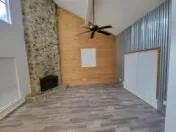 a view of an empty room with a fireplace