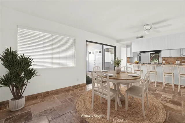 a view of a dining room with furniture and a potted plant