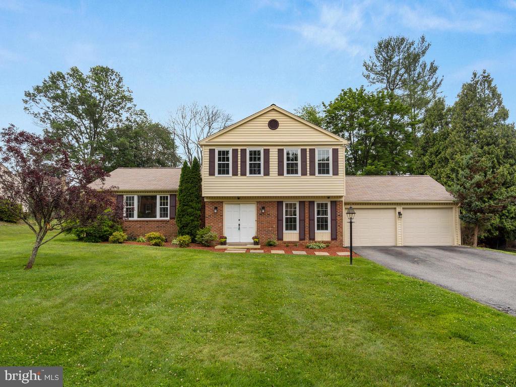 15121 Middlegate Road Silver Spring, MD 20905 - Photo 1 of 32 a front view of a house with a garden