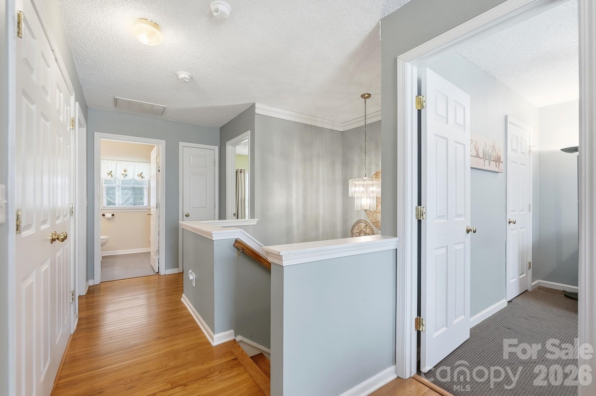 442 Sugar Maple Drive Tega Cay, SC 29708 - Photo 17 of 48 a view of a hallway to kitchen with wooden floor
