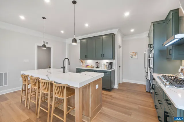 a large kitchen with kitchen island a sink stove and refrigerator