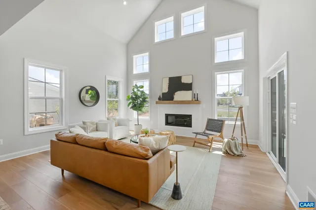a living room with furniture a fireplace and a window