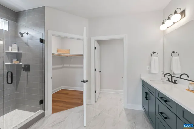 a bathroom with a double vanity sink a mirror and shower