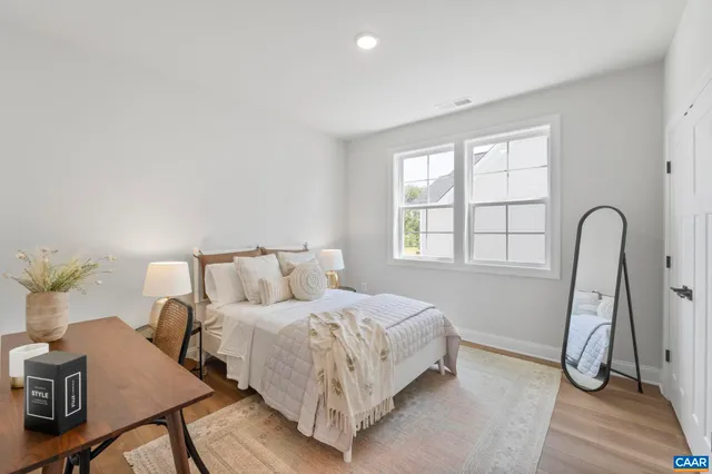 a bed room with a bed and a potted plant