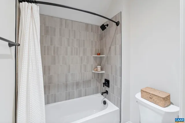 a bathroom with a bathtub and shower