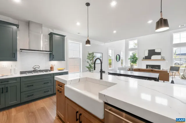 a large kitchen with kitchen island a sink stainless steel appliances and cabinets
