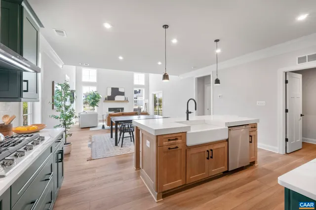 a kitchen with a sink stove and wooden cabinets
