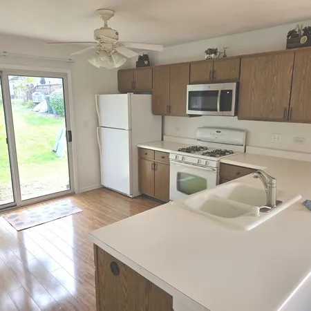 a kitchen with a stove a sink and a microwave