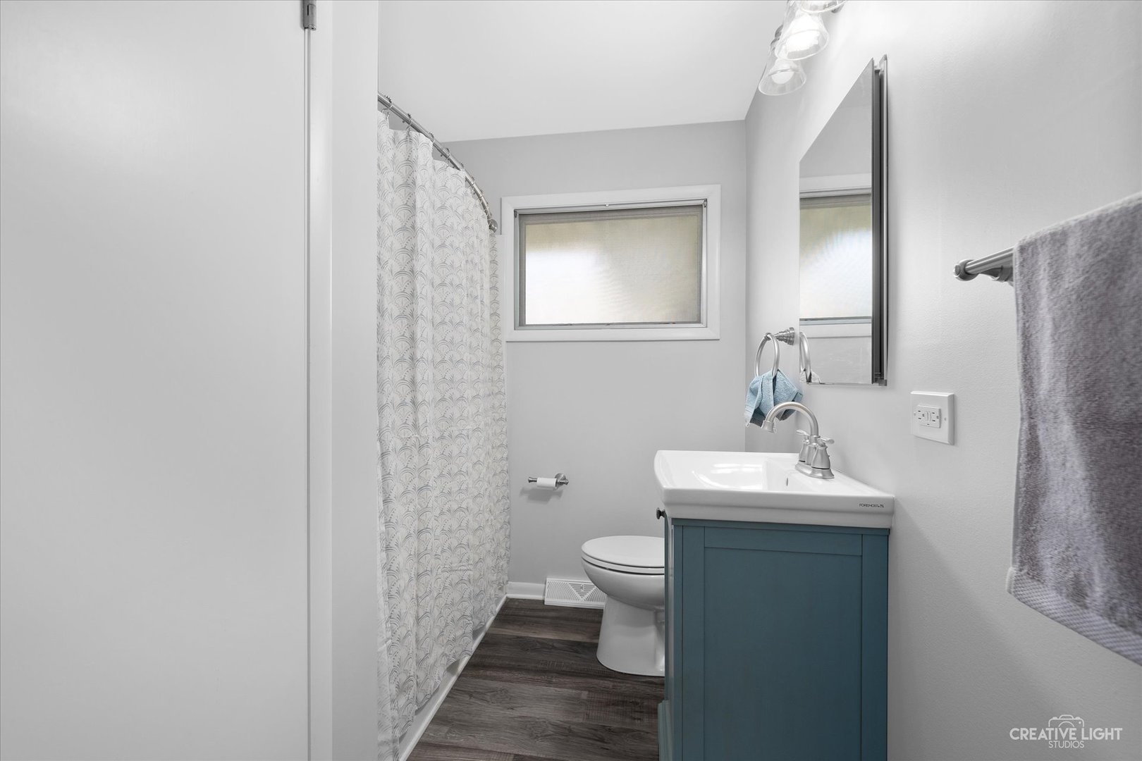 2114 Rockwell Road Aurora, IL 60506 - Photo 14 of 22 a bathroom with a toilet sink and mirror