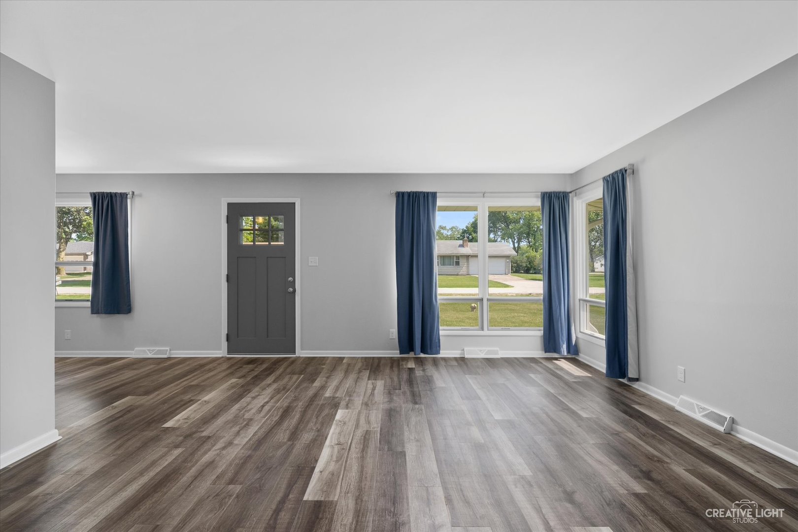 2114 Rockwell Road Aurora, IL 60506 - Photo 4 of 22 a view of an empty room with wooden floor and a window