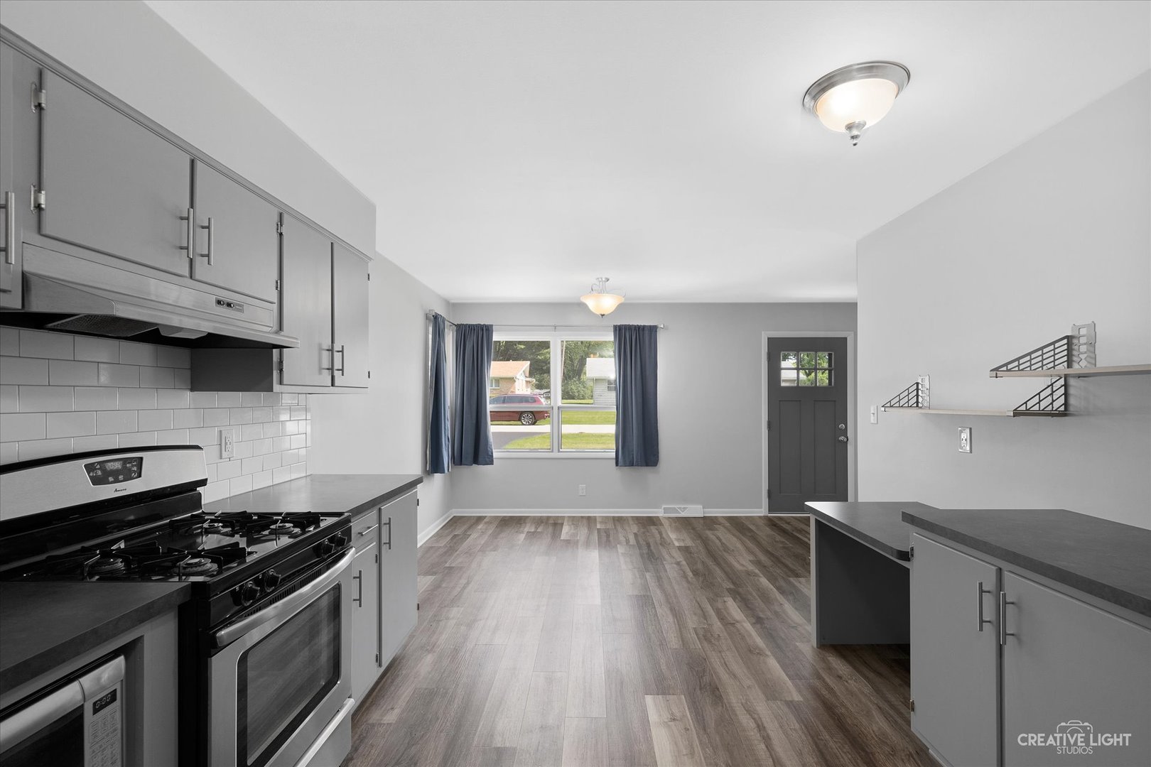 2114 Rockwell Road Aurora, IL 60506 - Photo 7 of 22 a kitchen with granite countertop wooden floors and stainless steel appliances