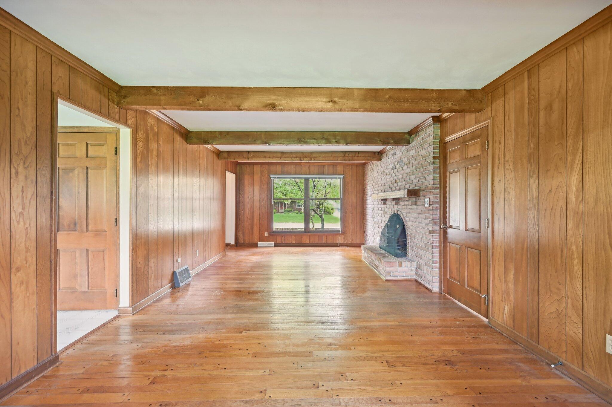 5917 Rocky Rill Road Columbus, OH 43235 - Photo 9 of 47 Family Room – Alternate Angle
Expansive living area with natural light, wood paneling, and hardwood floors—ideal for entertaining or relaxing.
