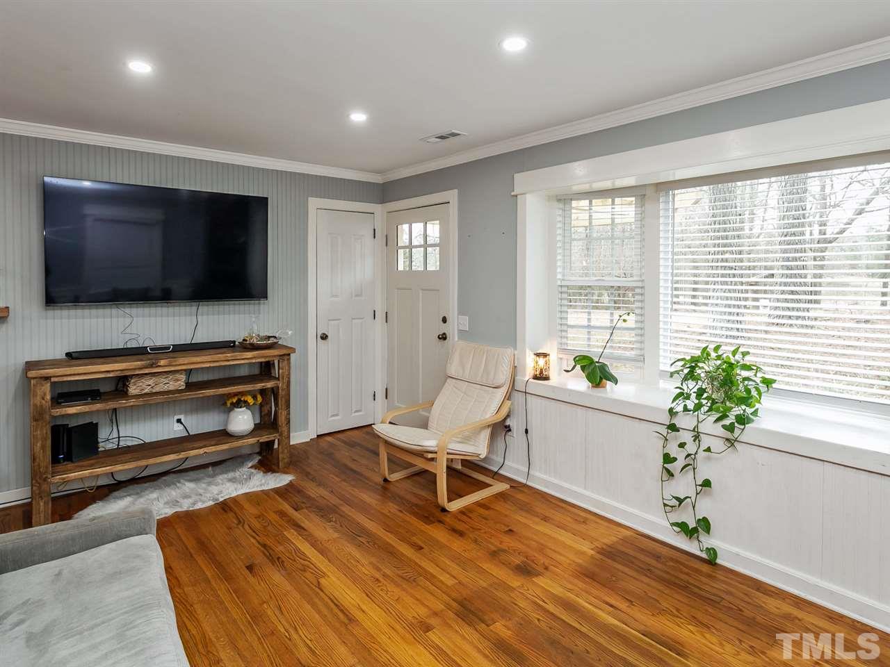 7532 Martin Road Zebulon, NC 27597 - Photo 2 of 26 a living room with furniture and a flat screen tv