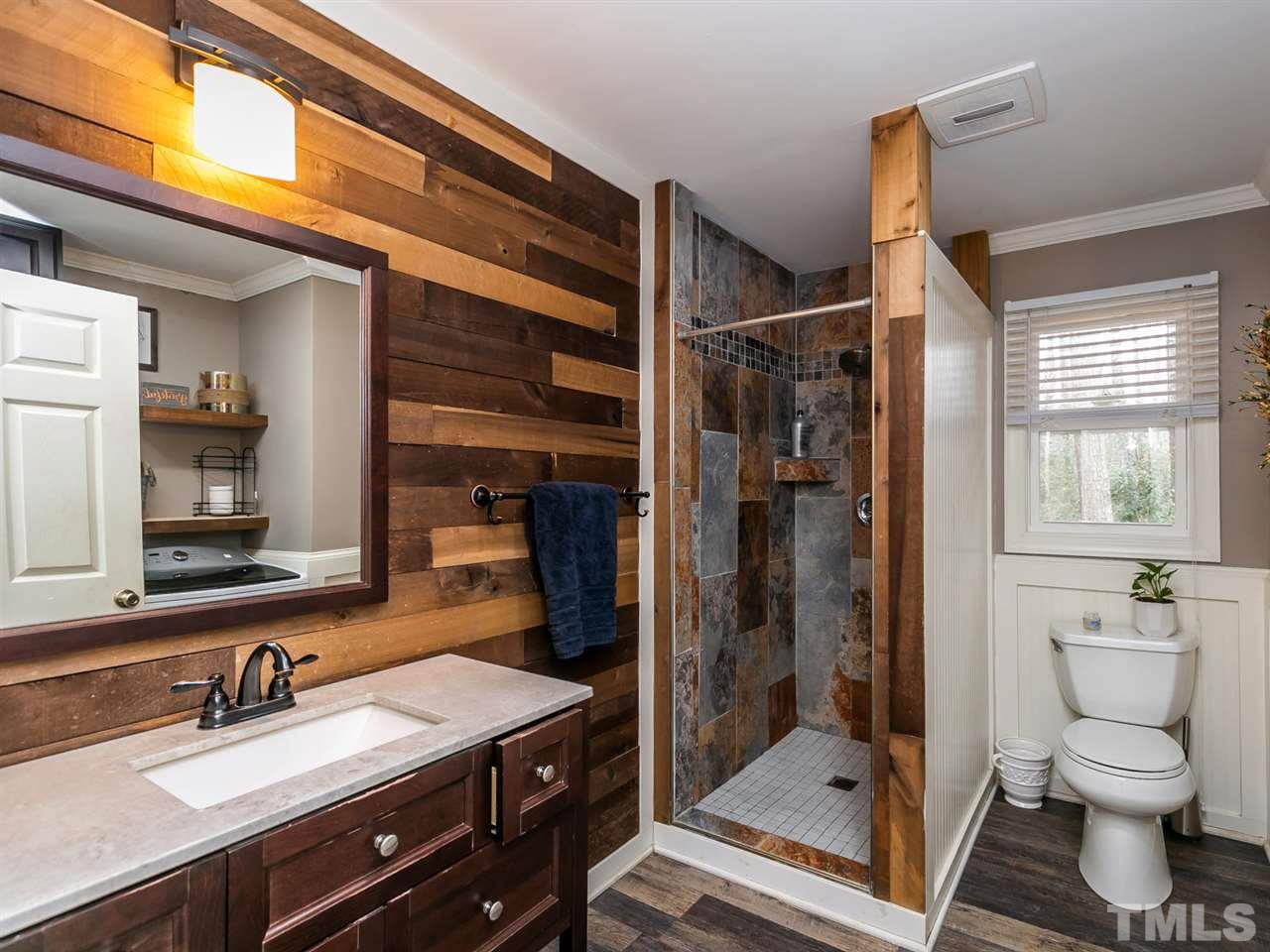 7532 Martin Road Zebulon, NC 27597 - Photo 15 of 26 a bathroom with a sink a toilet and shower