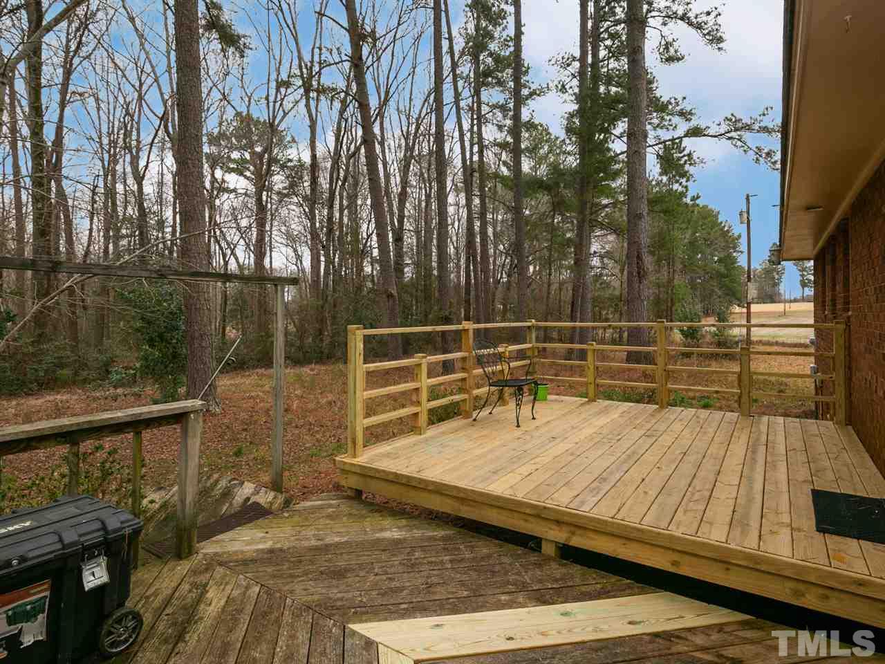 7532 Martin Road Zebulon, NC 27597 - Photo 22 of 26 a view of a balcony with wooden floor and outdoor seating